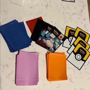 Pokemon Card Sleeves in Blue, Red, Purple, Orange, and Black